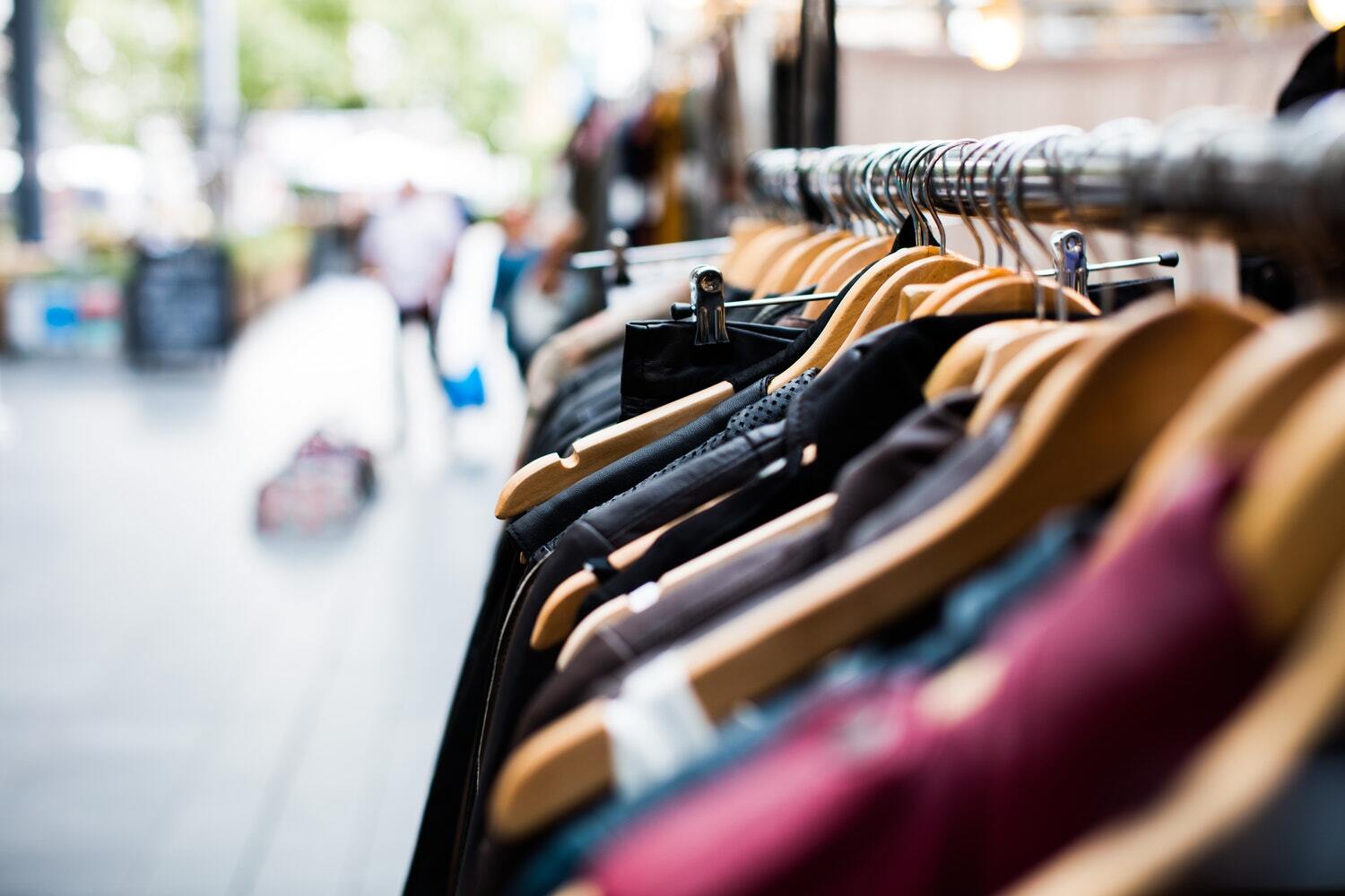 This is an image of clothing on a rack on the street.